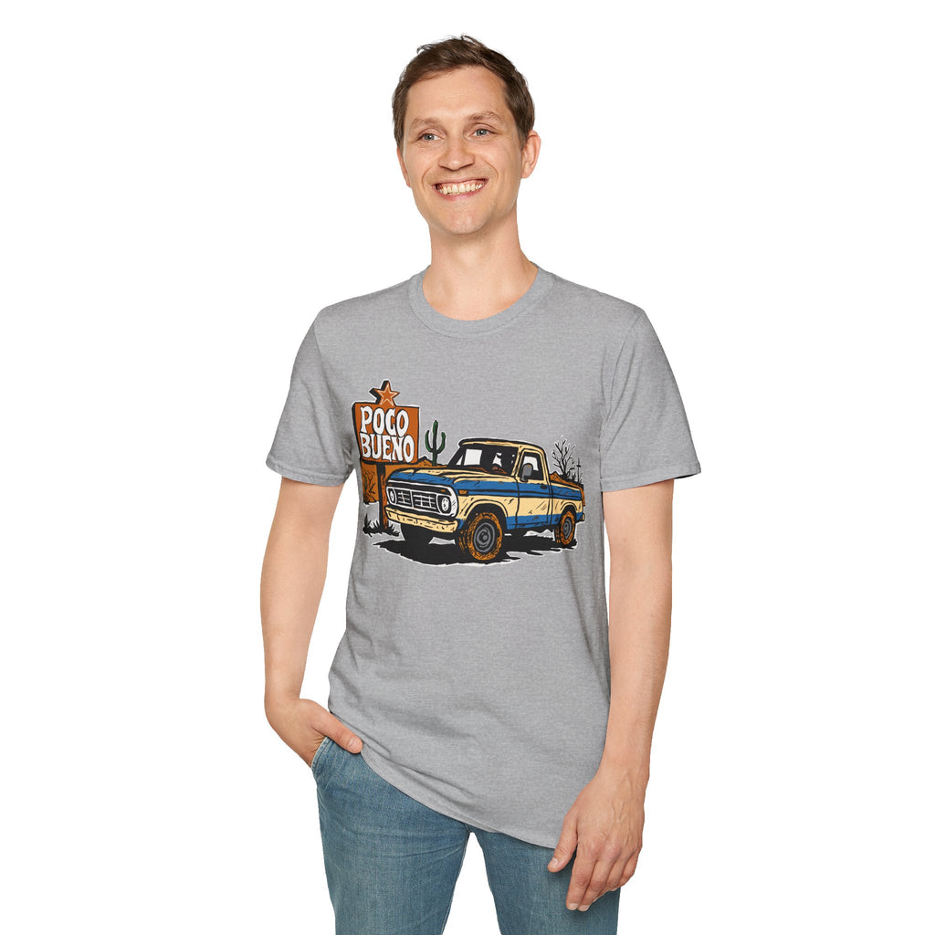 Person wearing a gray t-shirt with a graphic design of a pickup cowboy truck and 'Poco Bueno' desert road sign.